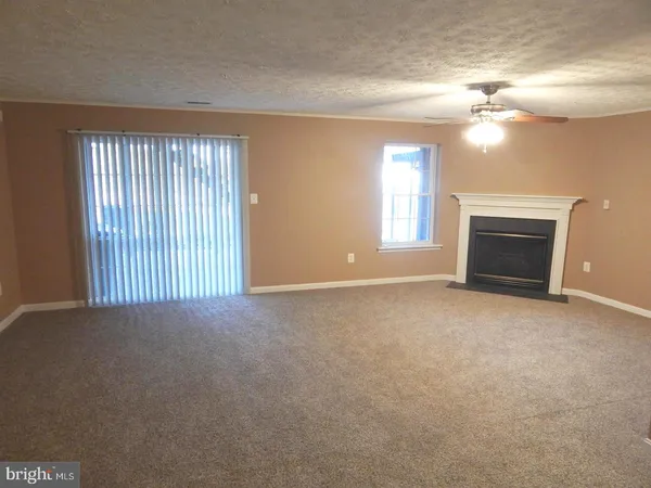 a view of empty room with a fireplace