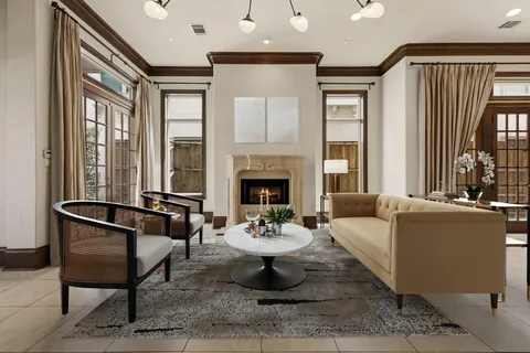 a living room with furniture a fireplace and a table