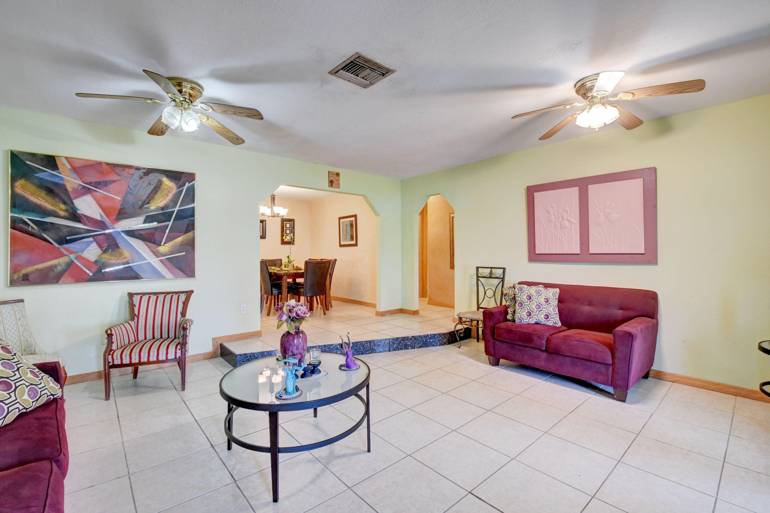 22790 Southwest 65th Avenue Boca Raton, FL 33428 - Photo 6 of 27 a living room with furniture and a chandelier