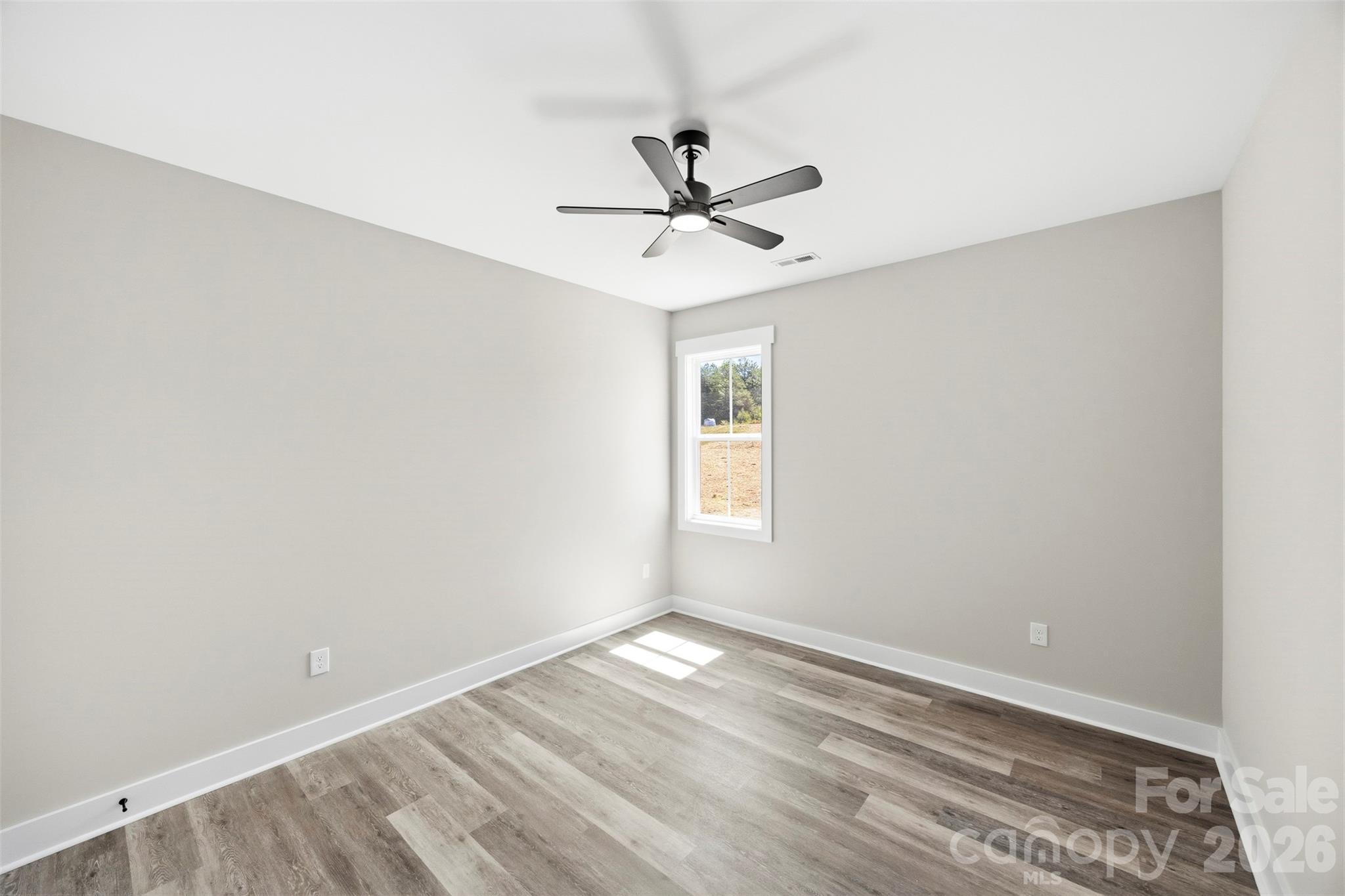1014 Speight Road Albemarle, NC 28001 - Photo 21 of 28 an empty room with a window and a ceiling fan