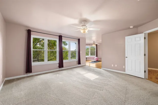 a view of a livingroom with a ceiling fan and window