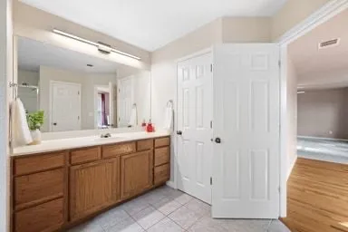 a spacious bathroom with a double vanity sink and a mirror
