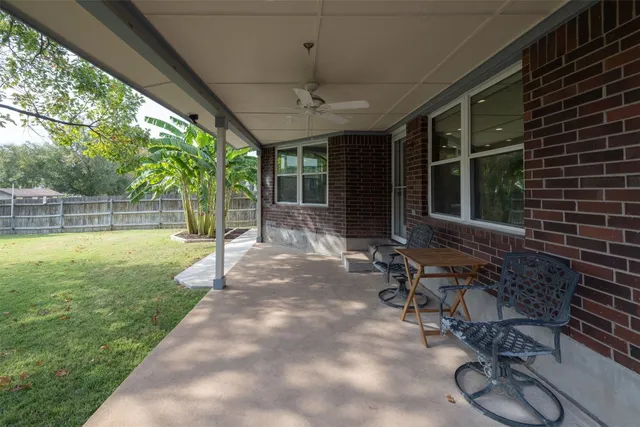 a view of a porch with chairs and backyard
