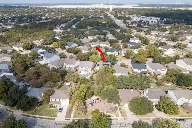 an aerial view of residential houses with outdoor space