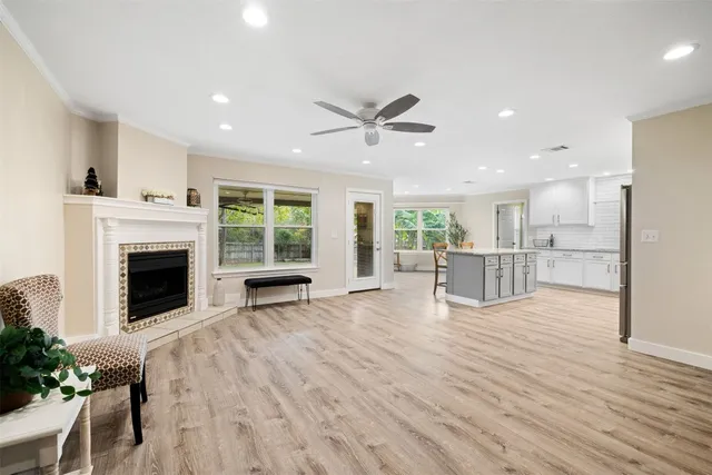 a view of a kitchen with furniture a fireplace and wooden floor