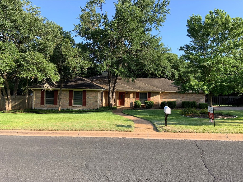 a house that has a tree in front of it