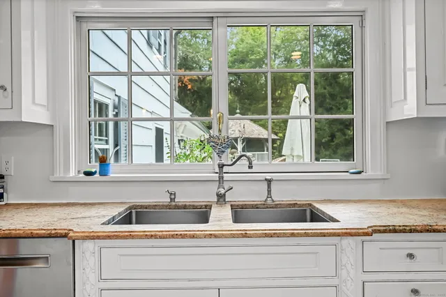 a kitchen with granite countertop a sink and a window