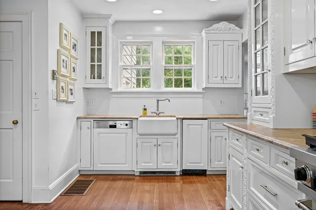 a view of a kitchen with cabinets and wooden floor