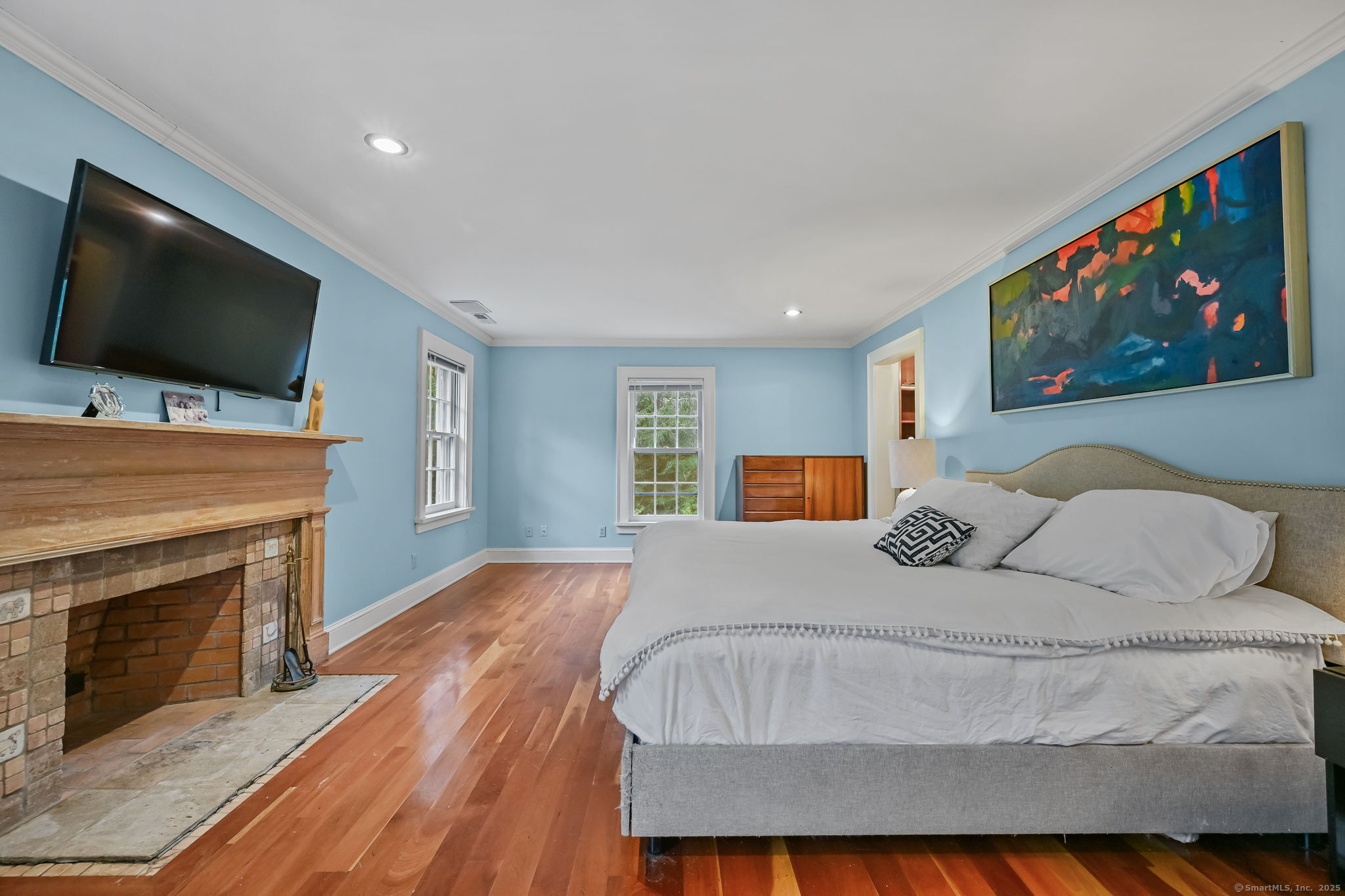 330 Ridgefield Road Wilton, CT 06897 - Photo 21 of 40 a bedroom with a bed and a flat screen tv