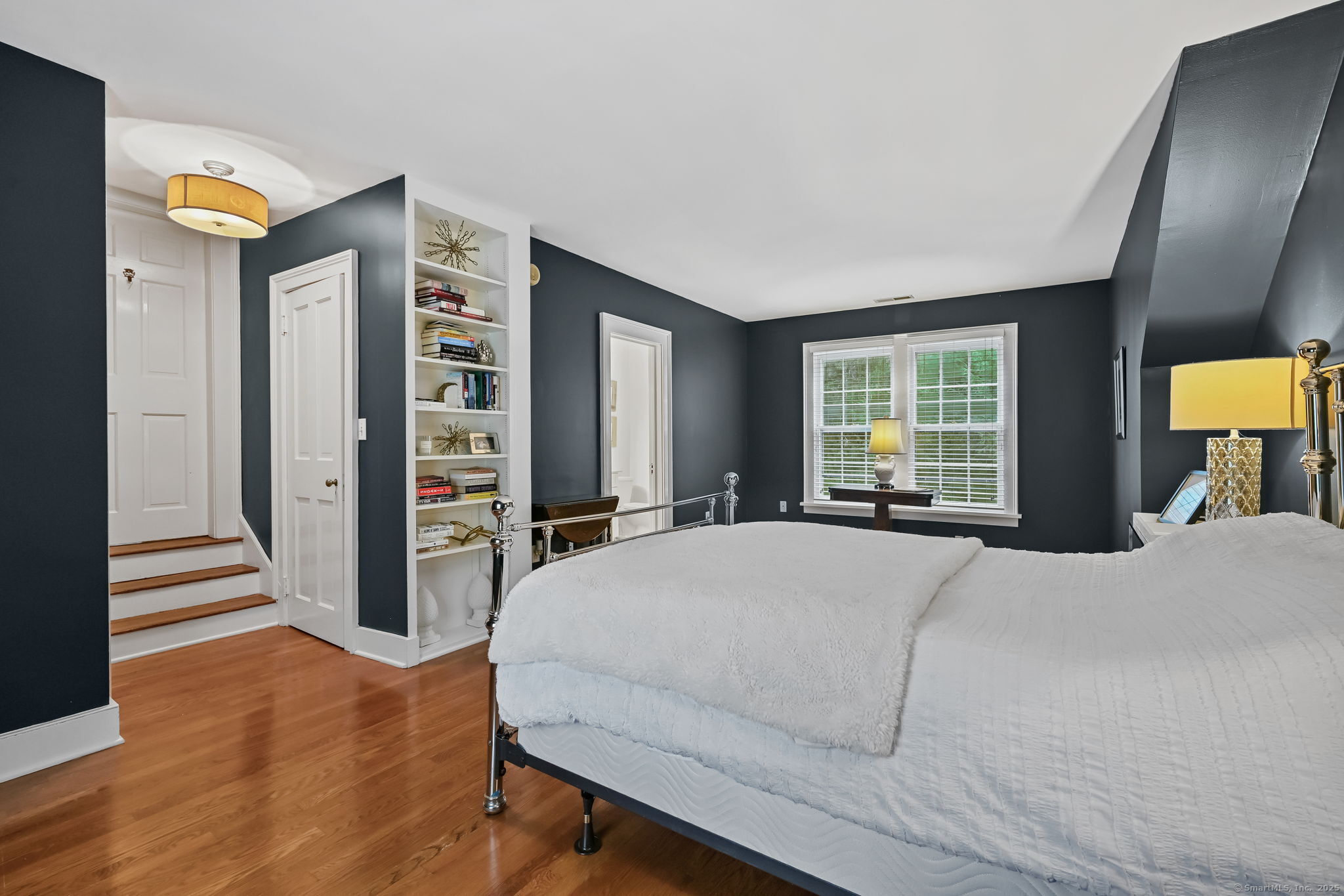 330 Ridgefield Road Wilton, CT 06897 - Photo 24 of 40 a bedroom with a bed and dresser with mirror