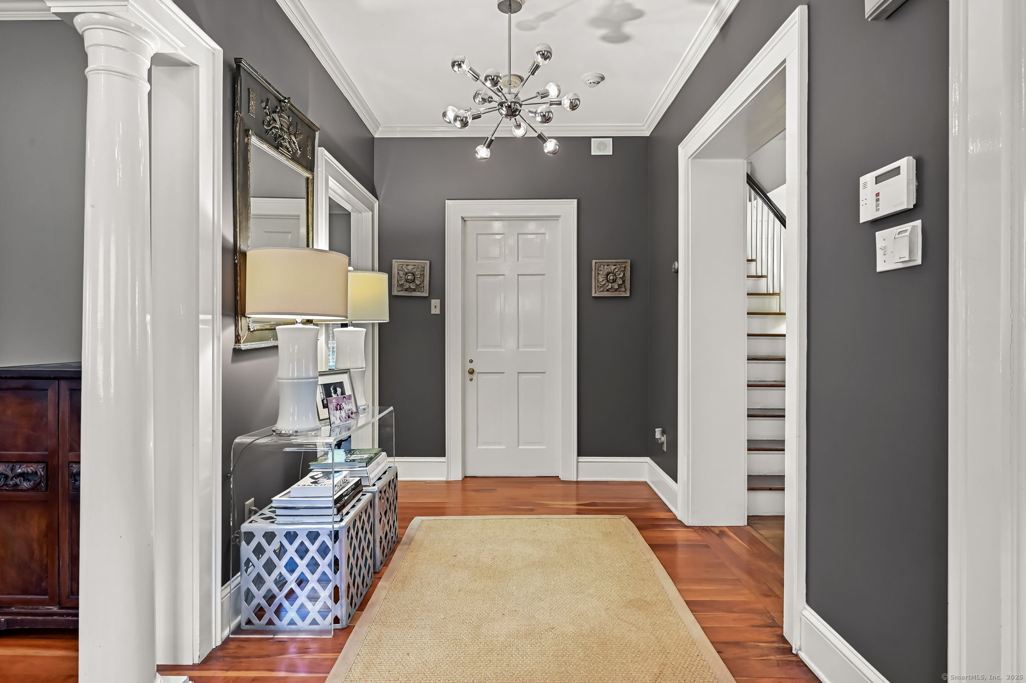 330 Ridgefield Road Wilton, CT 06897 - Photo 6 of 40 a living room with furniture and a chandelier