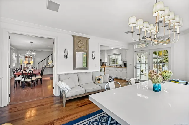 a living room with fireplace furniture and a chandelier