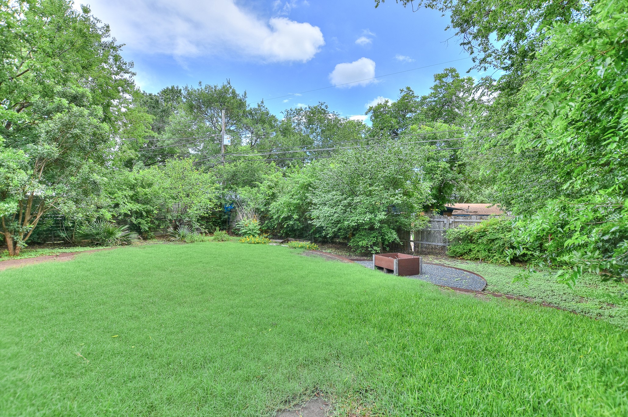 1309 Ridgemont Drive Austin, TX 78723 - Photo 33 of 35 Look at the privacy the current landscaping offers! Plus a great entertaining space around the custom fire pit!