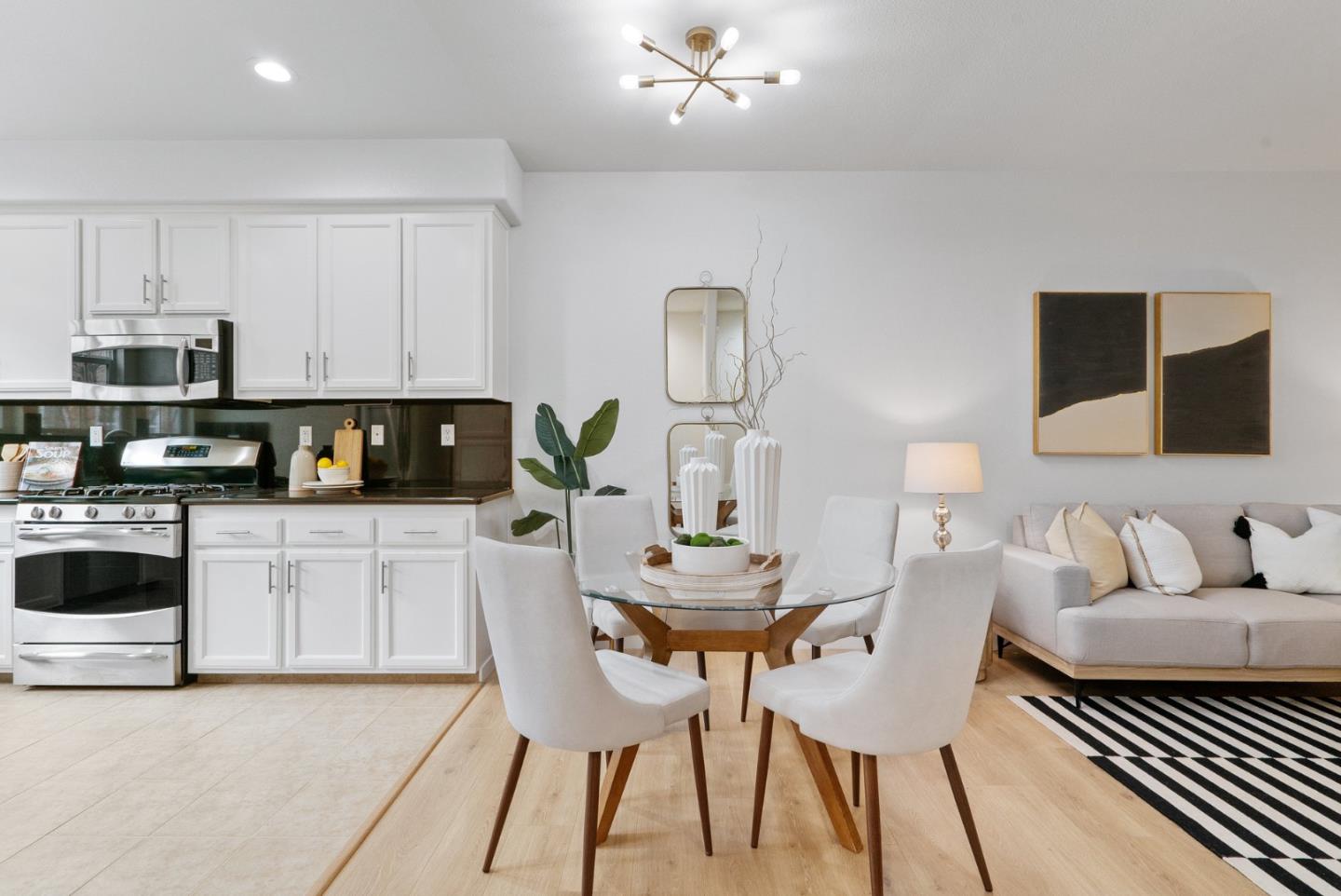 1520 Avina Circle, Unit 2 Santa Clara, CA 95054 - Photo 9 of 39 a kitchen with stainless steel appliances kitchen island granite countertop a sink a stove a microwave a dining table and chairs with wooden floor