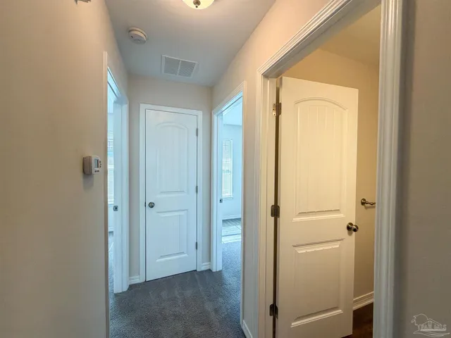 a view of a bathroom with a shower and a door