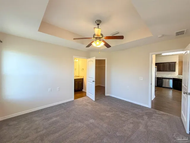 a view of a livingroom with a chandelier fan and fire place