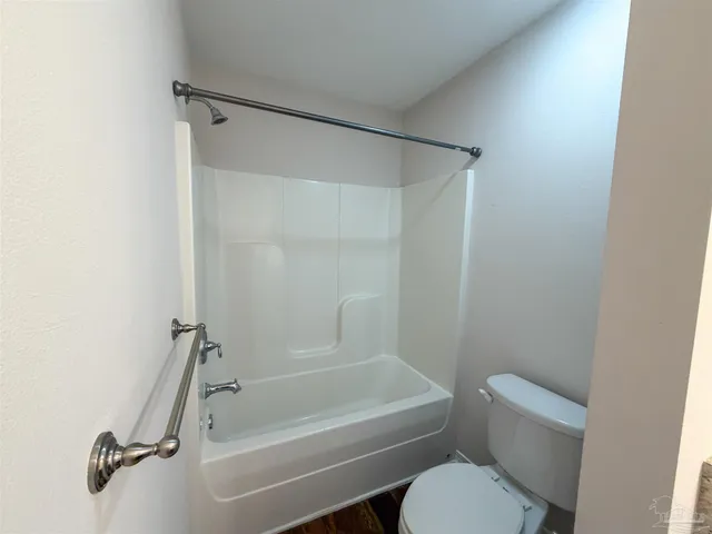 a bathroom with a toilet and a bathtub