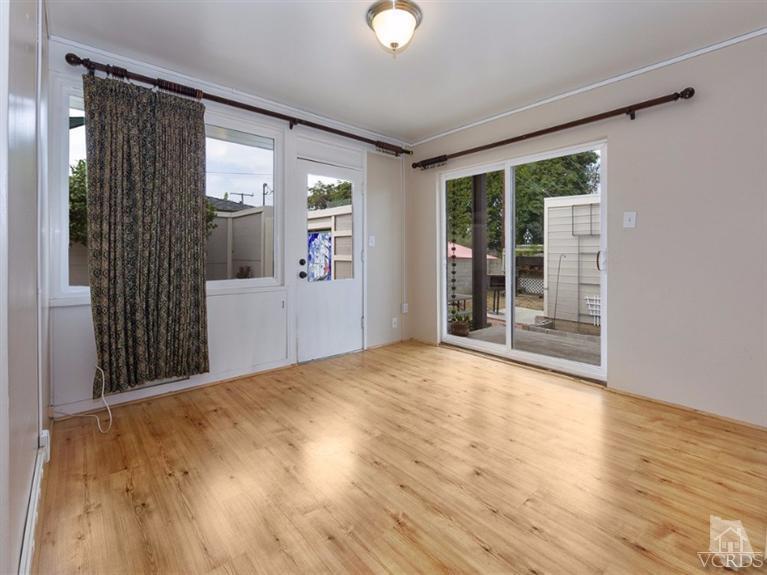 2542 Poli Street Ventura, CA 93003 - Photo 4 of 14 a view of an empty room with wooden floor and a window