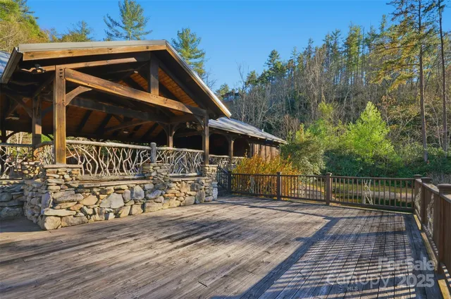 a view of a wooden deck with a yard