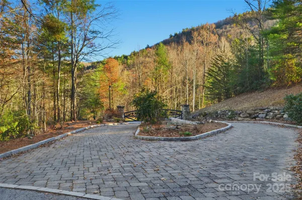 a backyard of a house with trees and outdoor seating