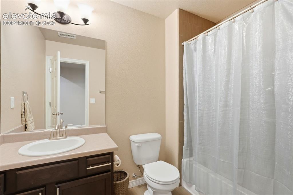 2264 Reed Grass Way Colorado Springs, CO 80915 - Photo 42 of 50 a bathroom with a toilet a sink and a mirror