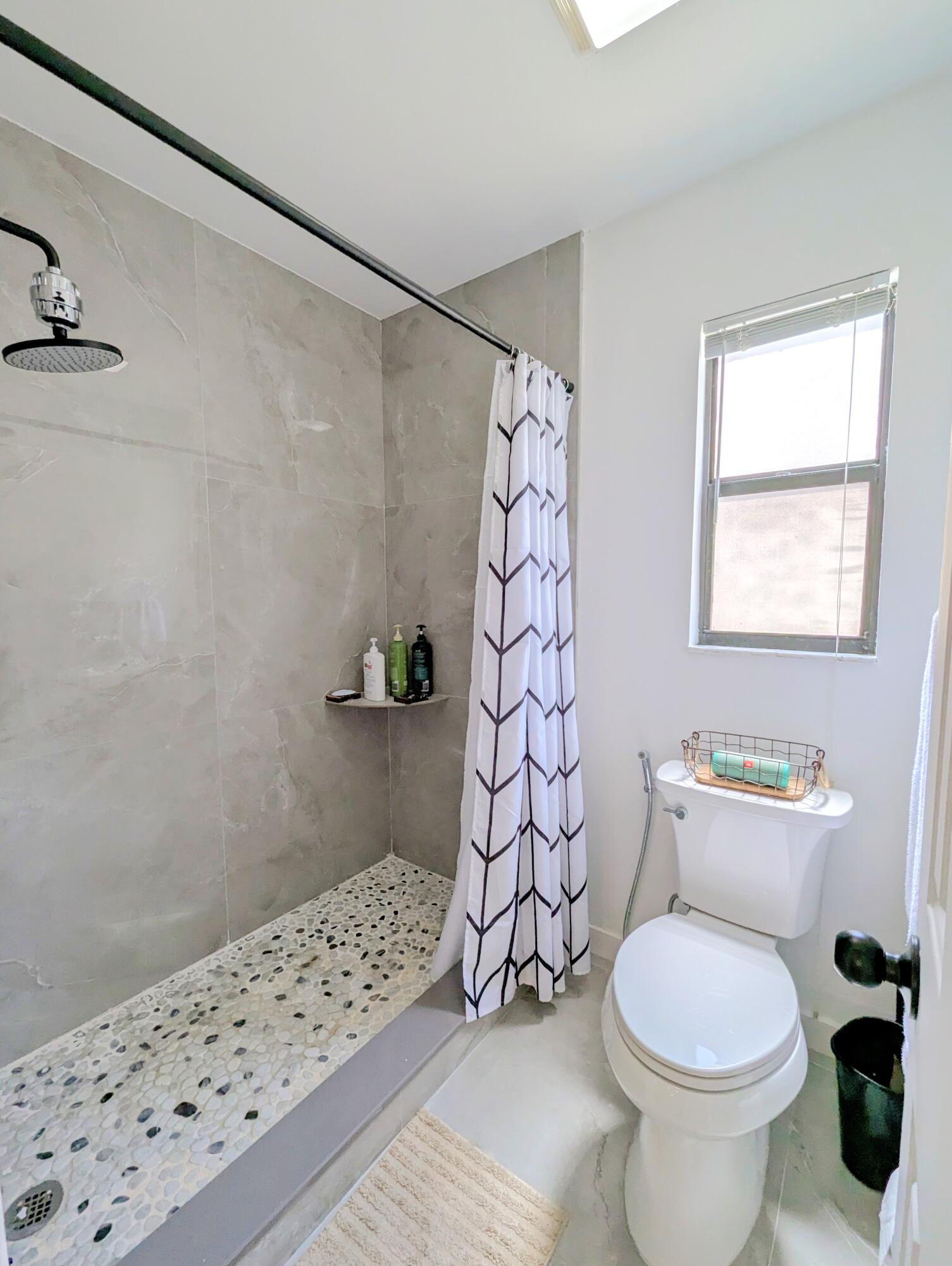 3130 Millwood Terrace, Unit 2160 Boca Raton, FL 33431 - Photo 11 of 34 a bathroom with a toilet and a shower