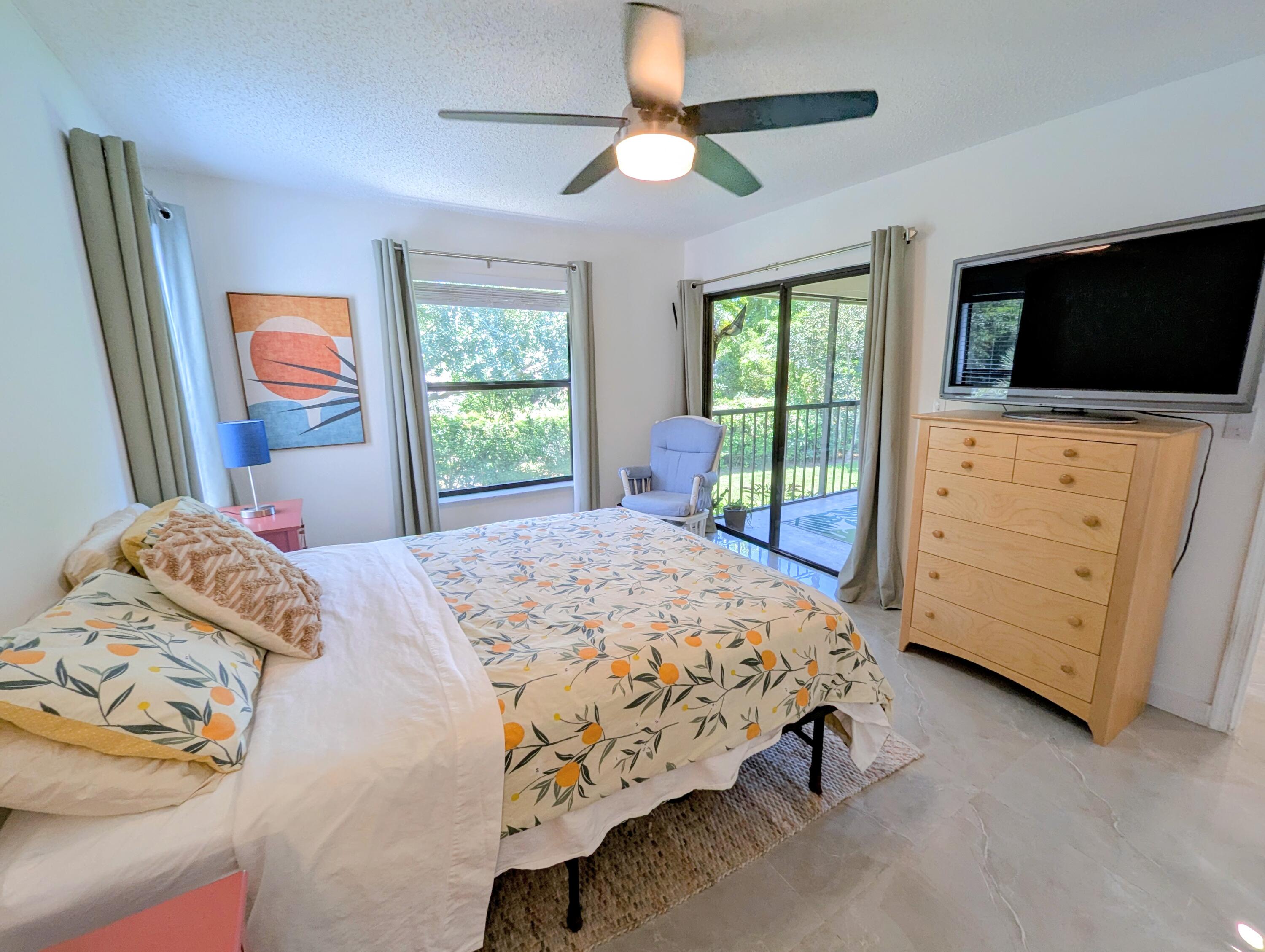 3130 Millwood Terrace, Unit 2160 Boca Raton, FL 33431 - Photo 17 of 34 a bedroom with a bed and a flat screen tv