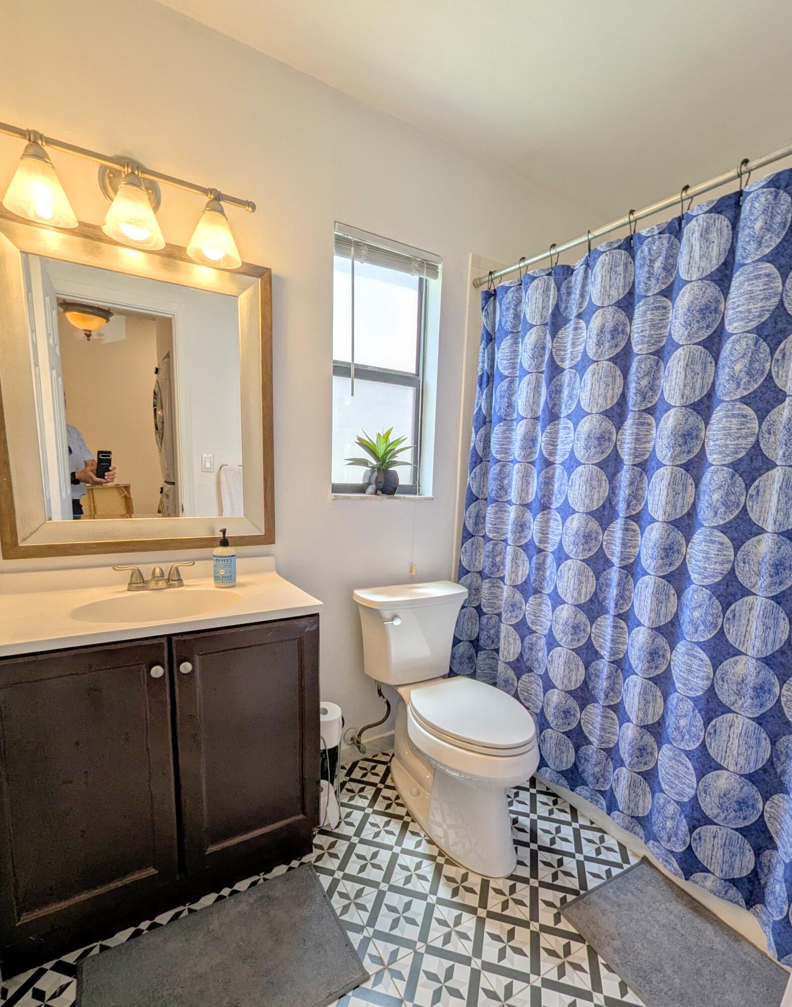3130 Millwood Terrace, Unit 2160 Boca Raton, FL 33431 - Photo 20 of 34 a bathroom with a sink toilet and mirror