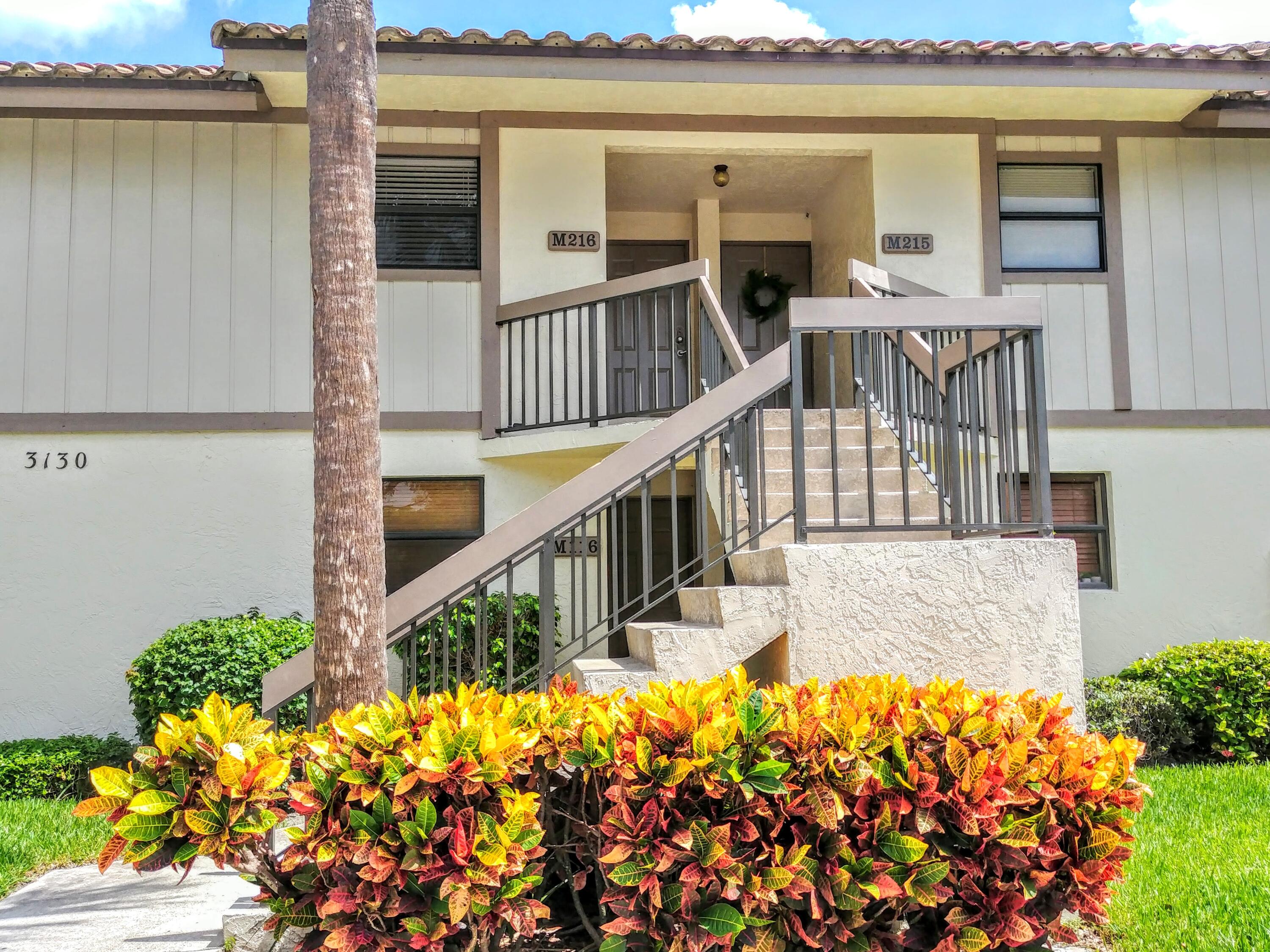 3130 Millwood Terrace, Unit 2160 Boca Raton, FL 33431 - Photo 2 of 34 front view of a house with a yard