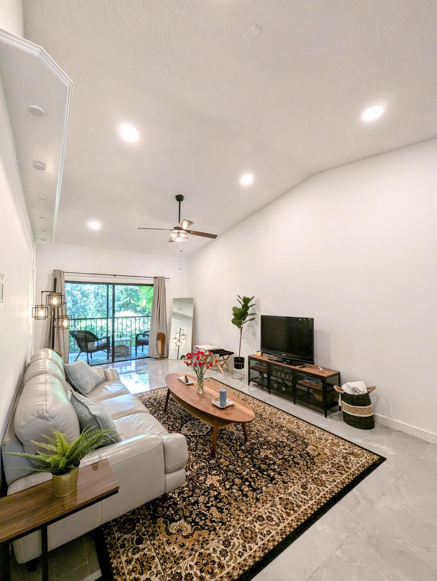 3130 Millwood Terrace, Unit 2160 Boca Raton, FL 33431 - Photo 21 of 34 a living room with furniture and a flat screen tv