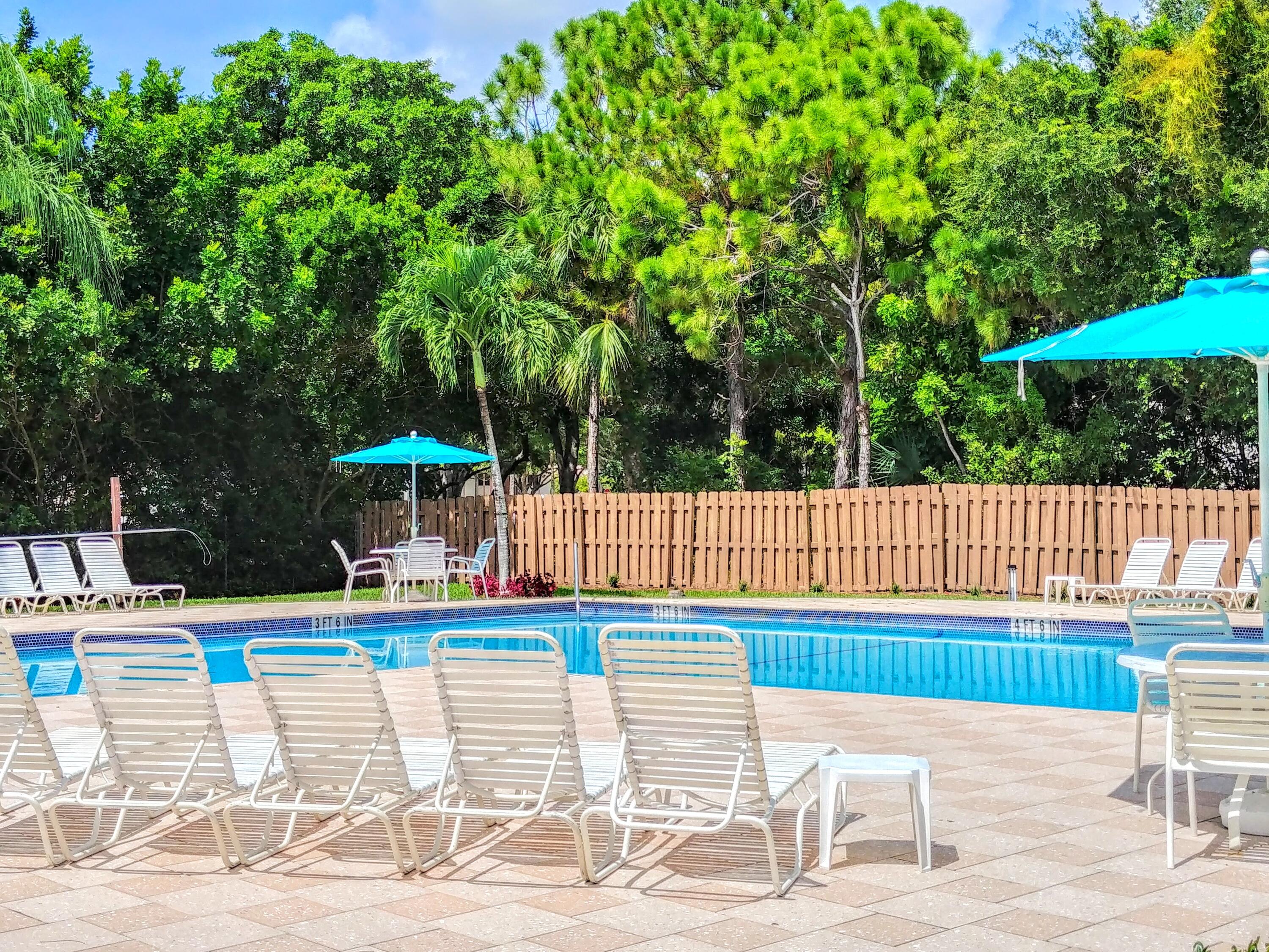 3130 Millwood Terrace, Unit 2160 Boca Raton, FL 33431 - Photo 23 of 34 a view of a swimming pool with an outdoor seating