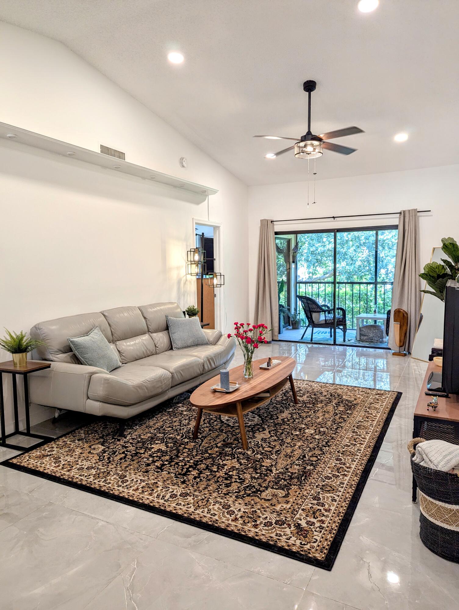 3130 Millwood Terrace, Unit 2160 Boca Raton, FL 33431 - Photo 3 of 34 a living room with furniture and a large window