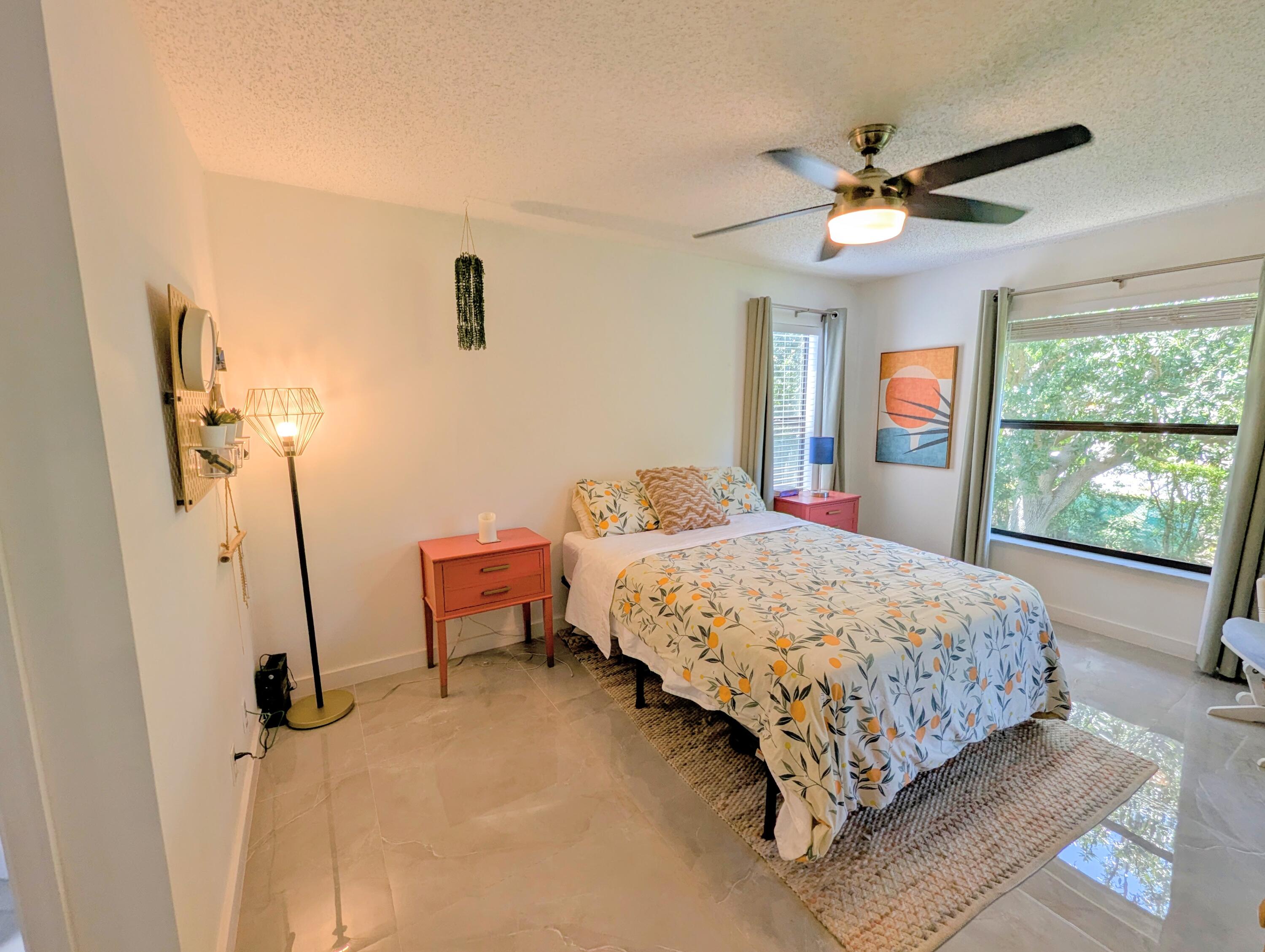 3130 Millwood Terrace, Unit 2160 Boca Raton, FL 33431 - Photo 9 of 34 a bedroom with a bed and a window