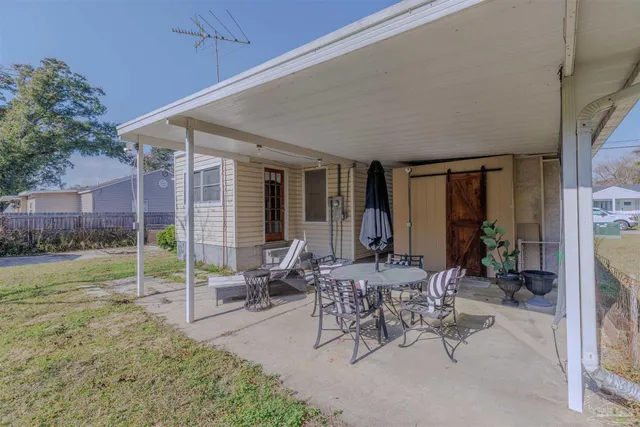 a view of a patio with a table chairs and a table