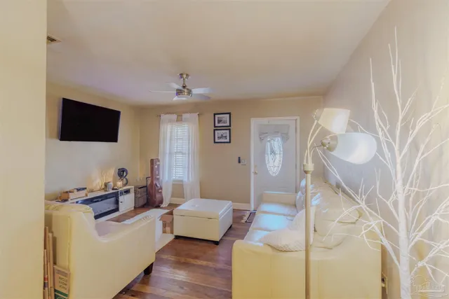 a living room with furniture and a flat screen tv