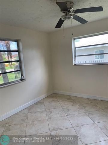 a bathroom with a granite countertop sink a mirror and a shower