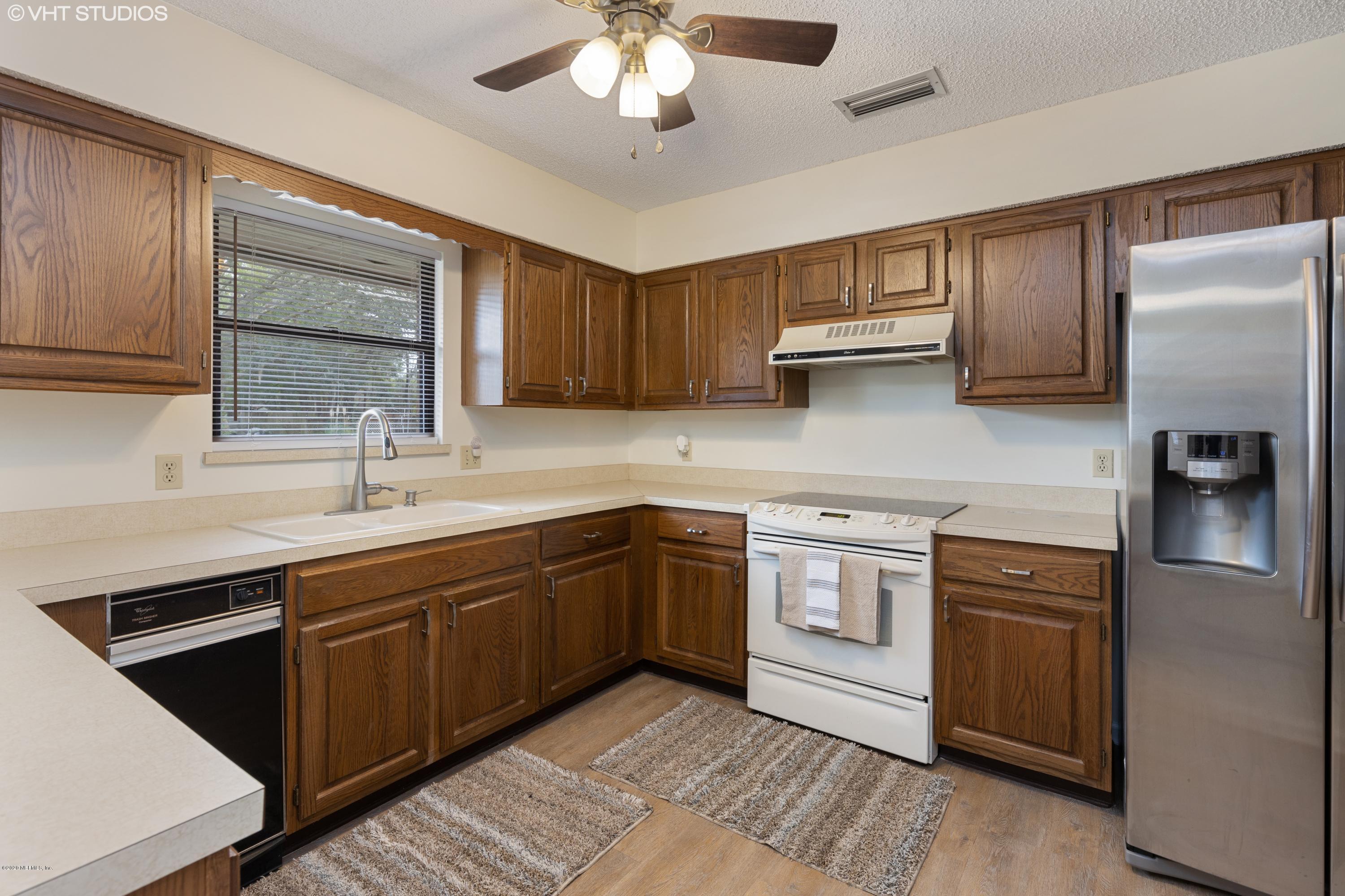6130 Carlton Road Jacksonville, FL 32244 - Photo 7 of 37 a kitchen with stainless steel appliances granite countertop a sink stove and refrigerator