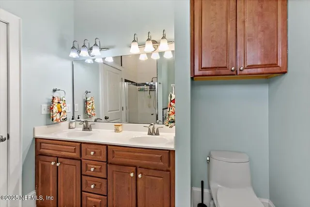 a bathroom with a sink vanity and toilet
