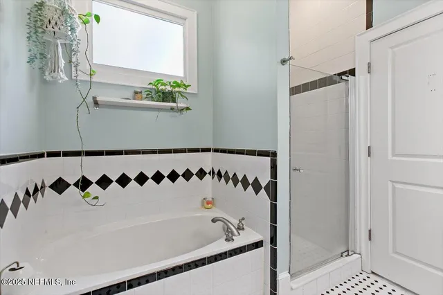 a bathroom with a bathtub and shower