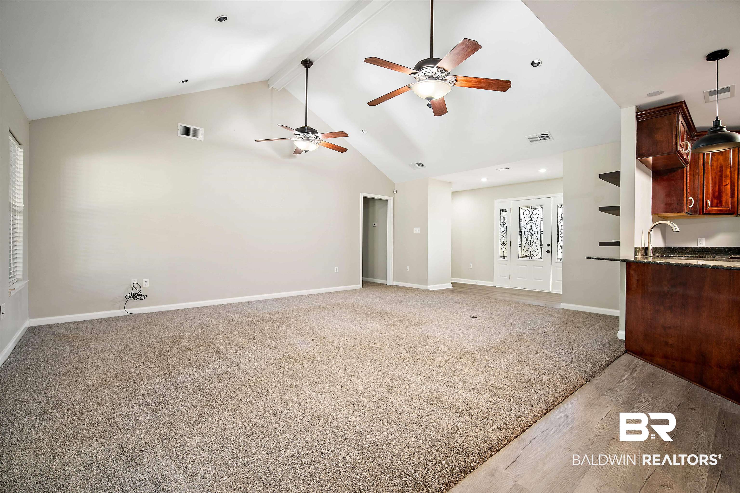 3010 Drag Strip Lane Coden, AL 36523 - Photo 10 of 44 Unfurnished living room featuring hardwood / wood-style flooring, sink, high vaulted ceiling, ceiling fan, and beam ceiling