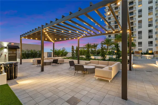 a view of patio with a table and chairs under an umbrella