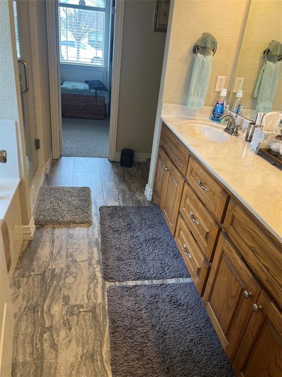 312 McAfee Street Mabank, TX 75147 - Photo 35 of 40 a bathroom with a granite countertop sink and a mirror