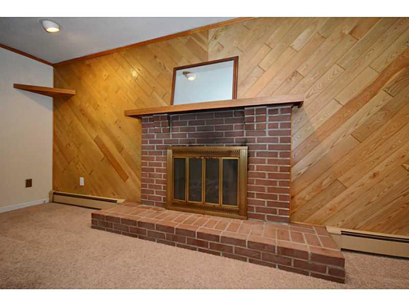 120 Foxcroft Road Pittsburgh, PA 15220 - Photo 21 of 25 Other. Detailed view of gas fireplace in family room with brick hearth and wood mantle.