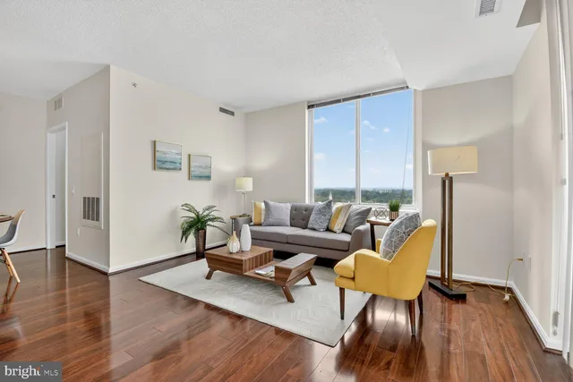 a living room with furniture rug and wooden floor