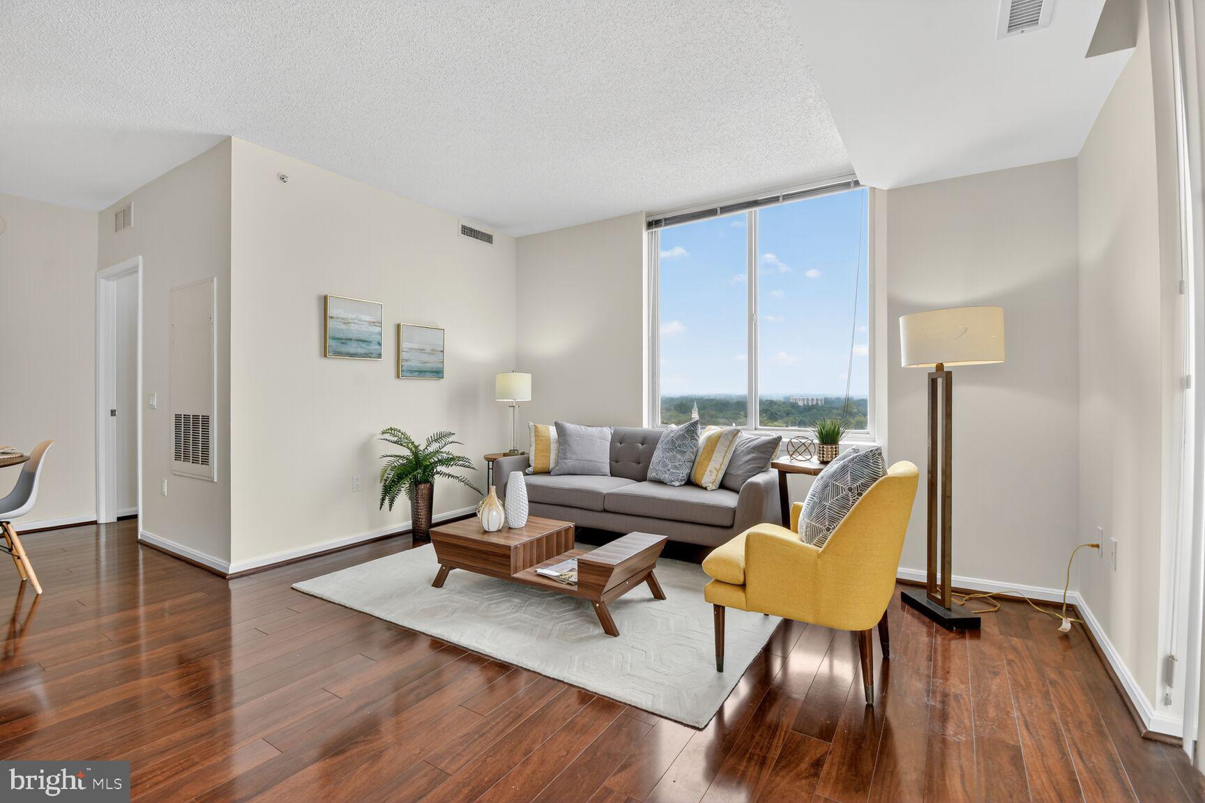 930 Wayne Avenue, Unit 1210 Silver Spring, MD 20910 - Photo 11 of 42 a living room with furniture rug and wooden floor