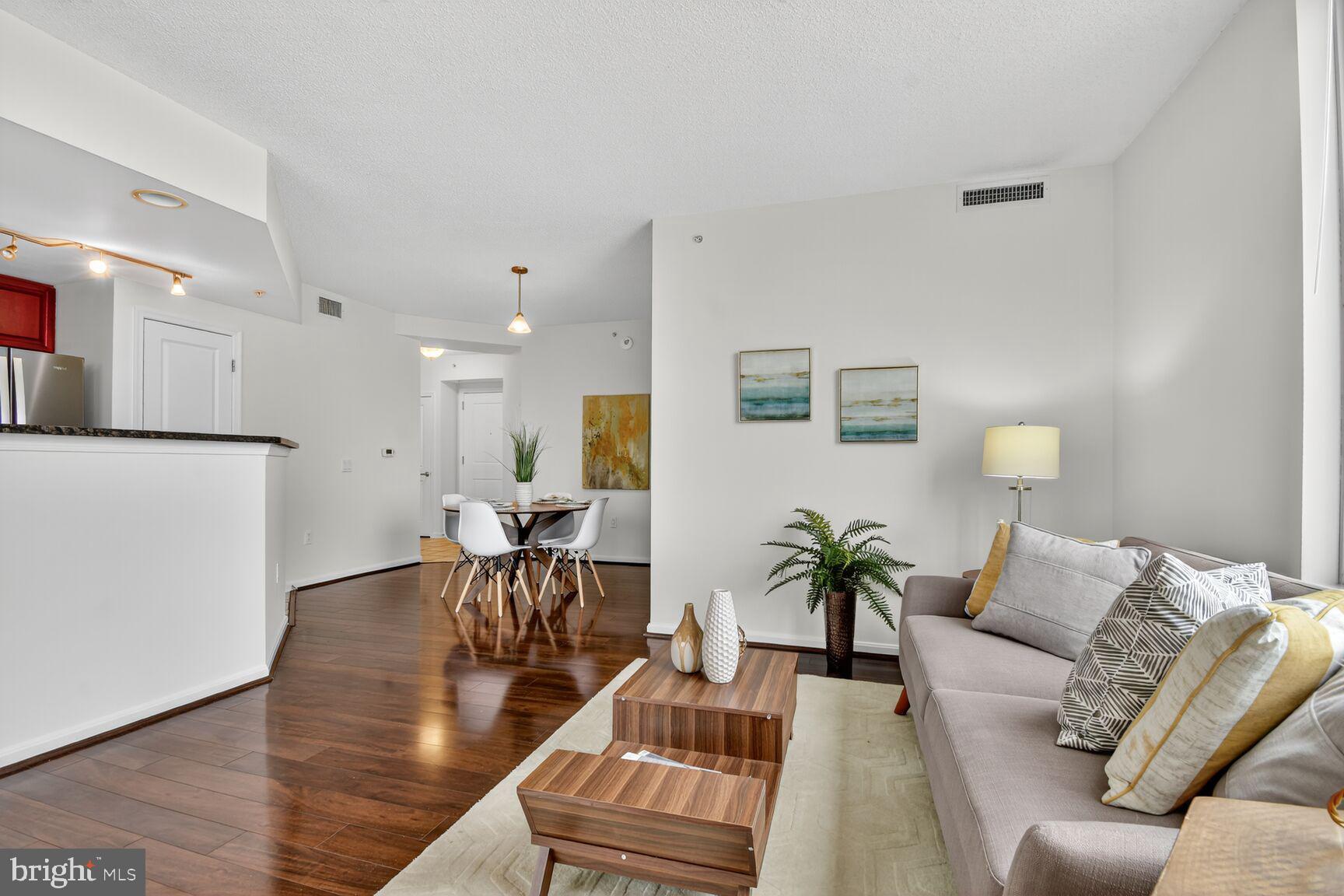 930 Wayne Avenue, Unit 1210 Silver Spring, MD 20910 - Photo 12 of 42 a living room with furniture and wooden floor