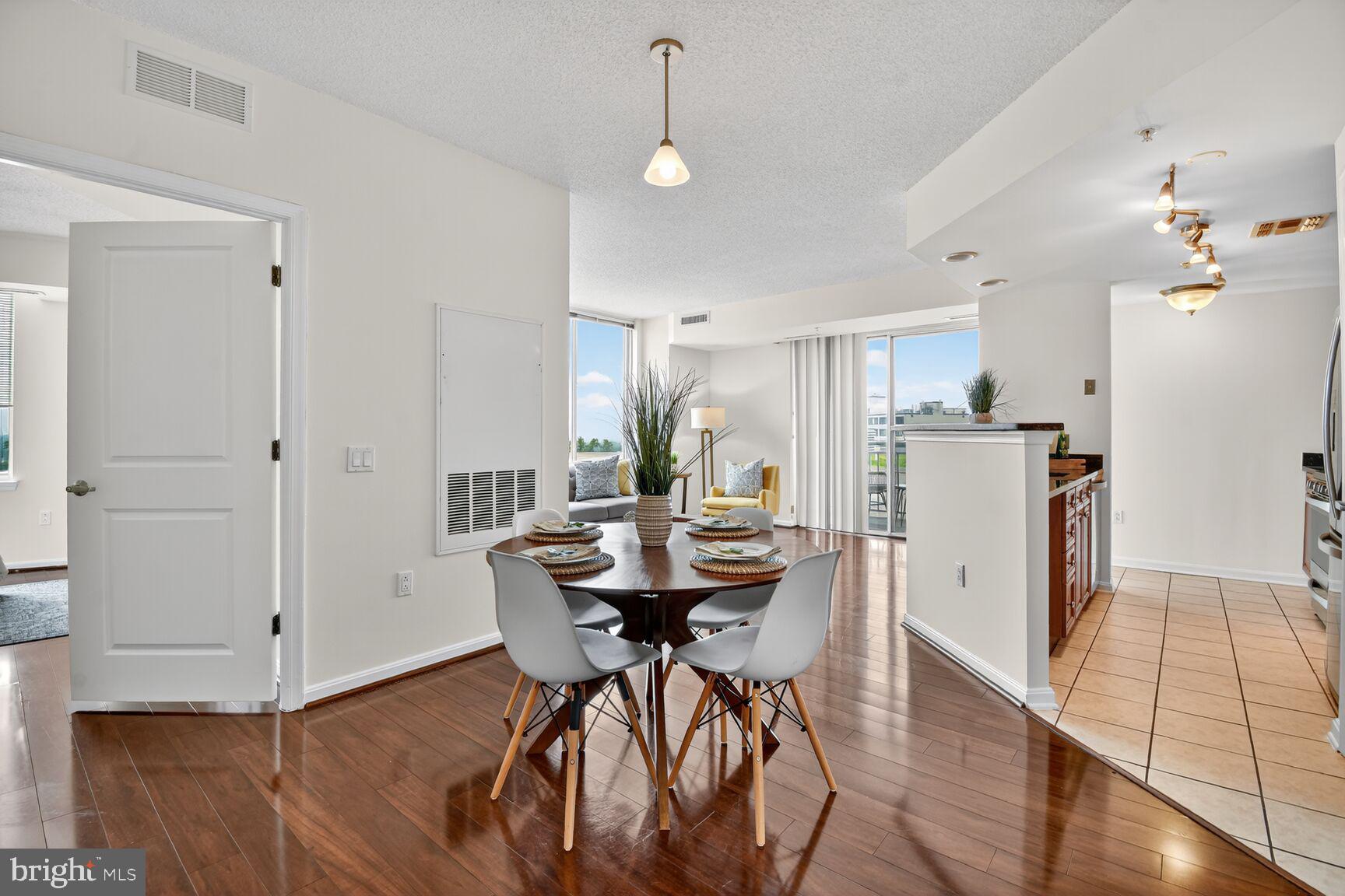 930 Wayne Avenue, Unit 1210 Silver Spring, MD 20910 - Photo 14 of 42 a view of a dining room with furniture and wooden floor