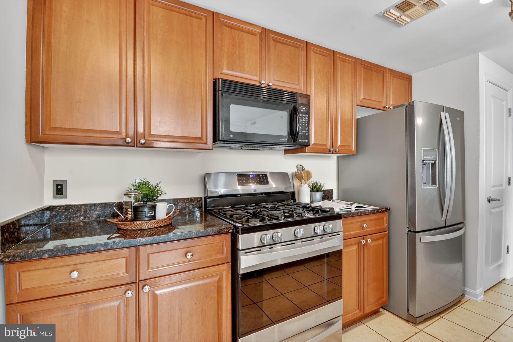 930 Wayne Avenue, Unit 1210 Silver Spring, MD 20910 - Photo 15 of 42 a kitchen with appliances a sink and cabinets