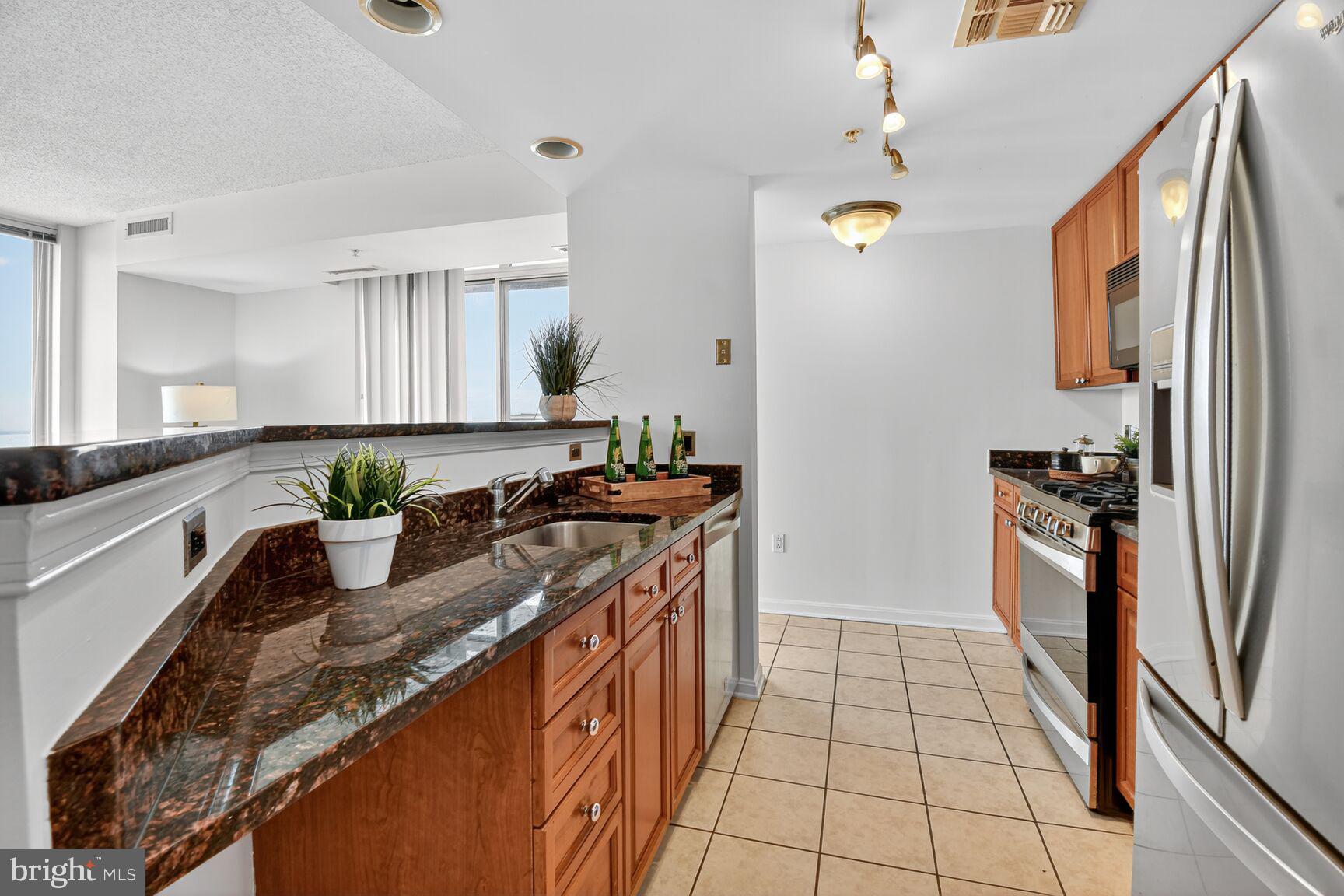 930 Wayne Avenue, Unit 1210 Silver Spring, MD 20910 - Photo 16 of 42 a kitchen with stainless steel appliances granite countertop a sink and a stove