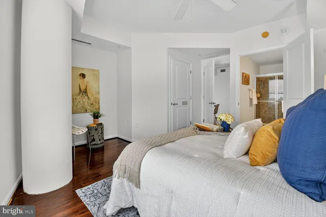 a bedroom with a bed and wooden floor